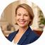 Nancy Ratter smiling in a softly lit coaching office